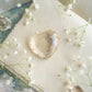 Faceted Citrine heart amongst a journal surrounded by flowers, wax seal, selenite, quartz and citrine towers in a romantic monet style sight